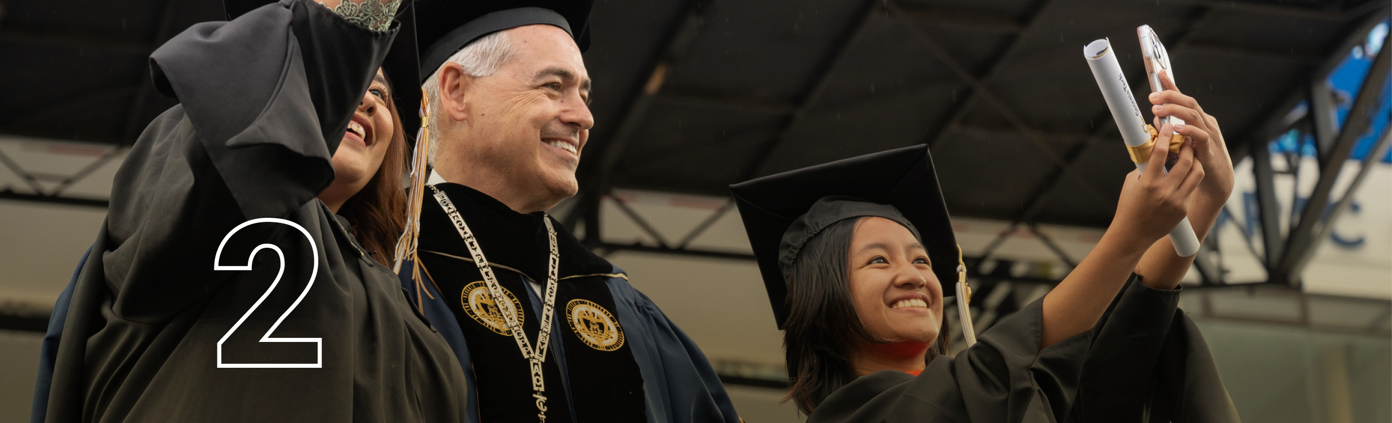 Happy grads taking a selfie with President Cabrera